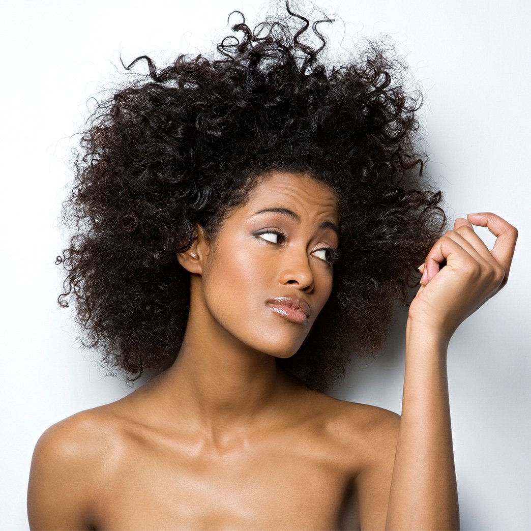 Woman wondering how to fix frizzy hair - Garnier